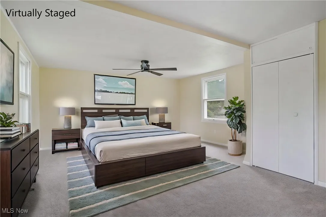 Bedroom featuring carpet floors, baseboards, and ceiling fan