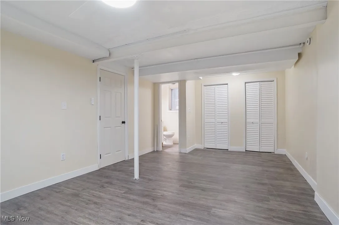 Finished basement featuring wood finished floors and baseboards