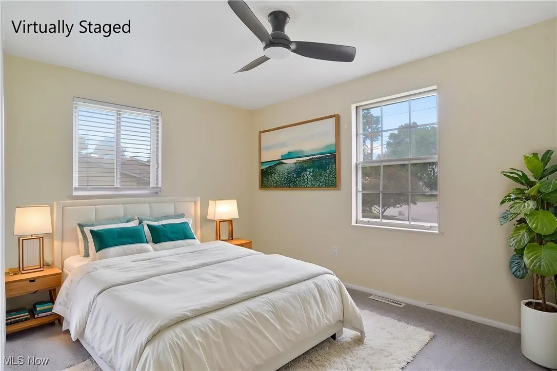 Carpeted bedroom featuring baseboards and a ceiling fan