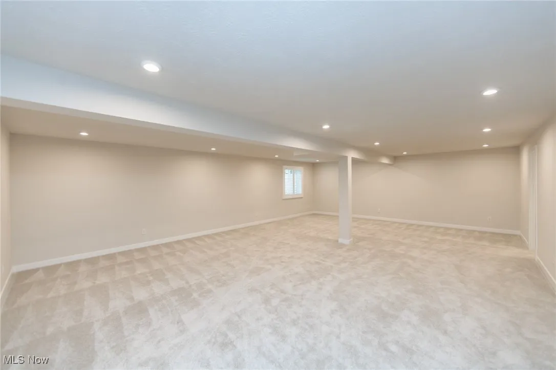 Basement featuring light carpet, recessed lighting, and baseboards