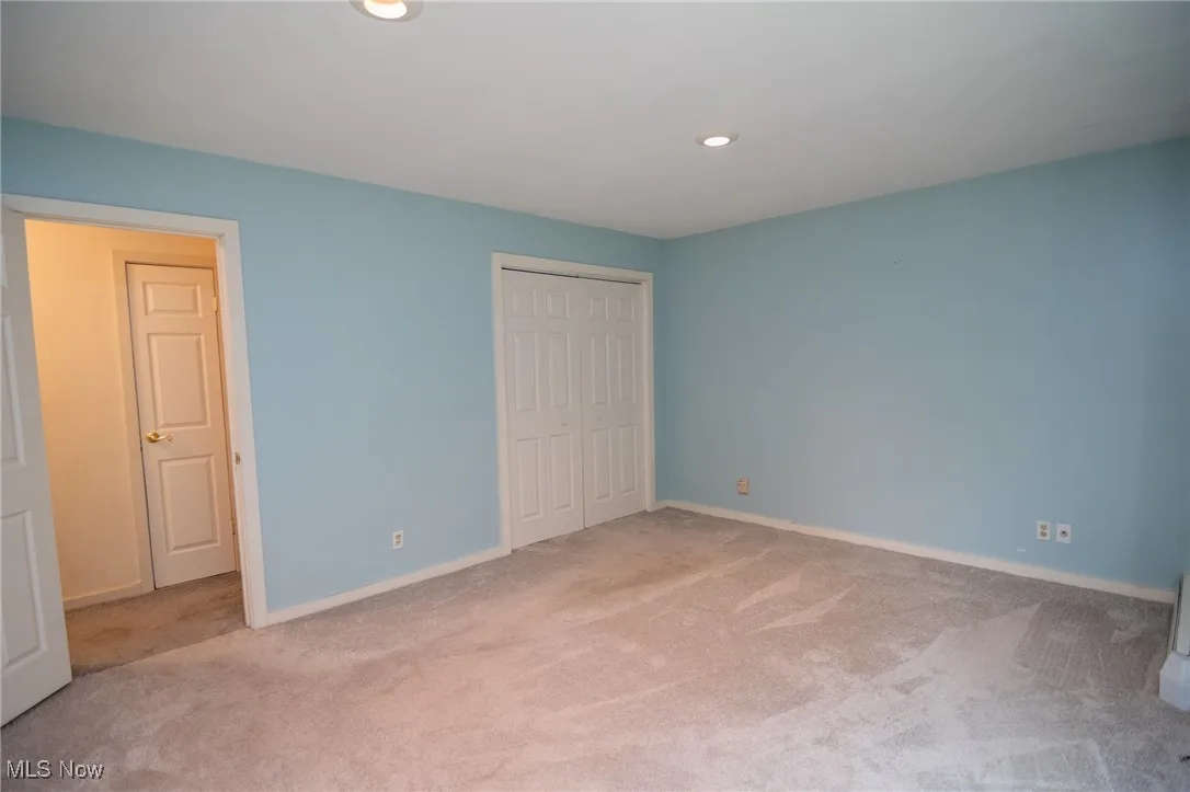 Unfurnished bedroom featuring carpet floors, a closet, recessed lighting, and baseboards