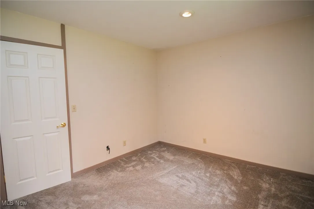 Carpeted empty room featuring baseboards