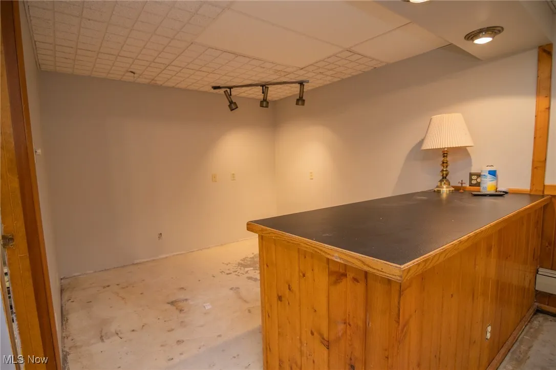 Office space featuring a bar and concrete flooring
