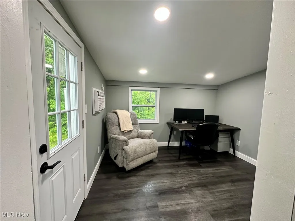 Office area featuring a wall mounted air conditioner, recessed lighting, dark wood finished floors, baseboards, and vaulted ceiling