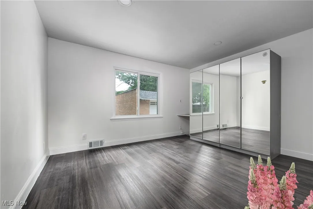 Unfurnished bedroom with wood finished floors