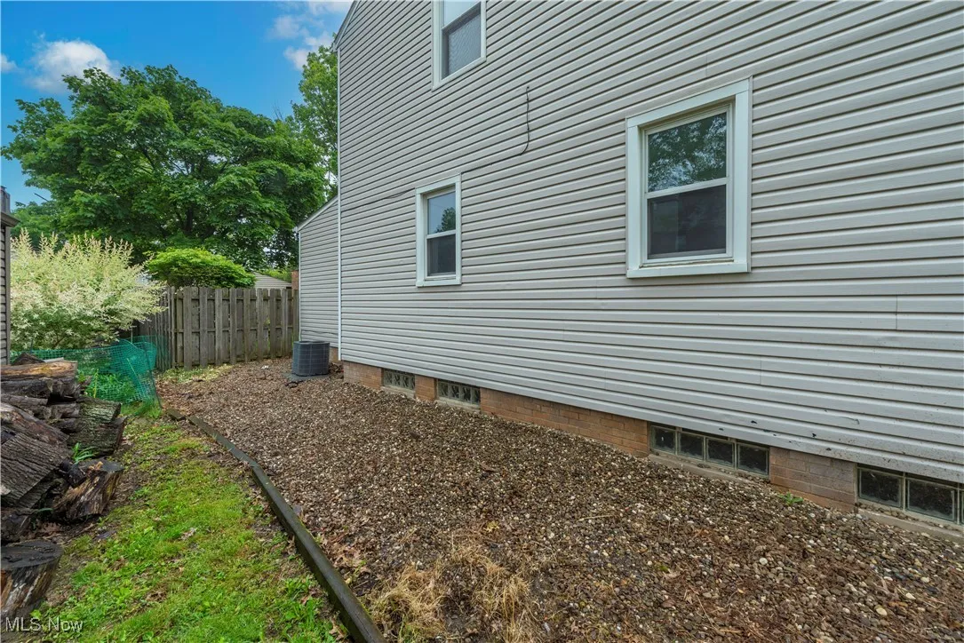 View of home's exterior with central AC (AC has been replaced since photographed)