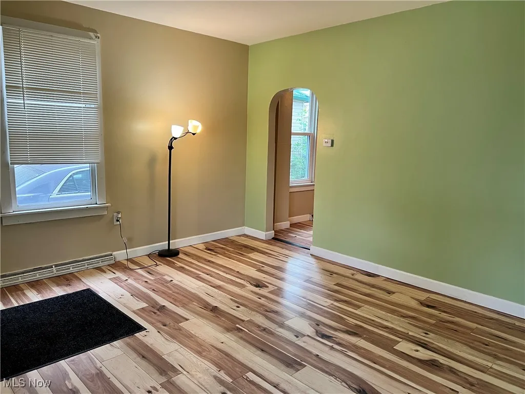Large living room with arched doorway into kitchen