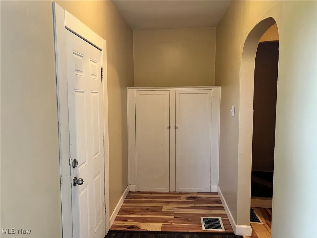 Mud room with built ins and arched doorway