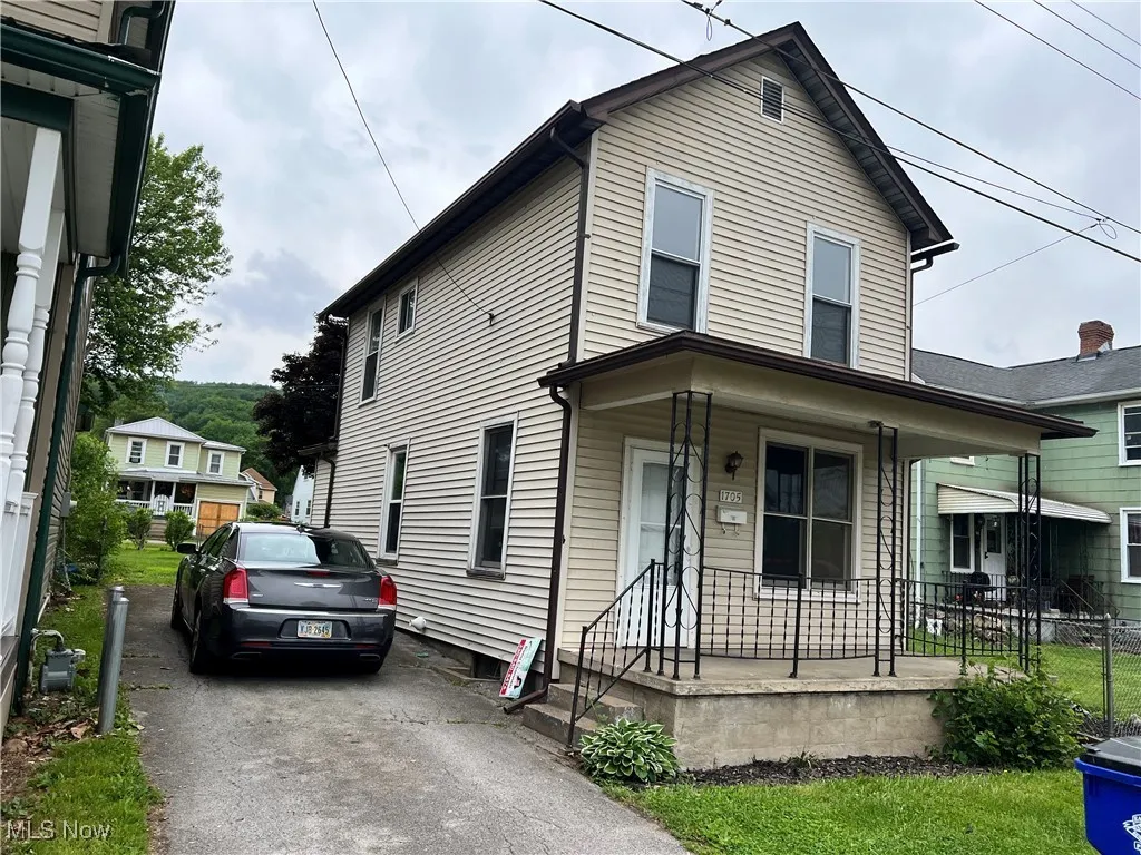 View of front facade with a porch and driveway
