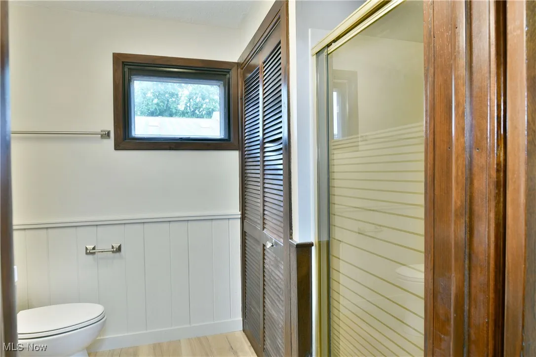 Bathroom featuring toilet and wainscoting