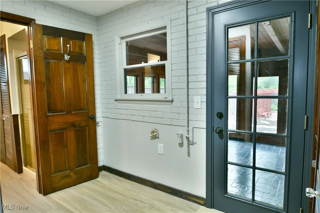 Doorway with light wood-type flooring