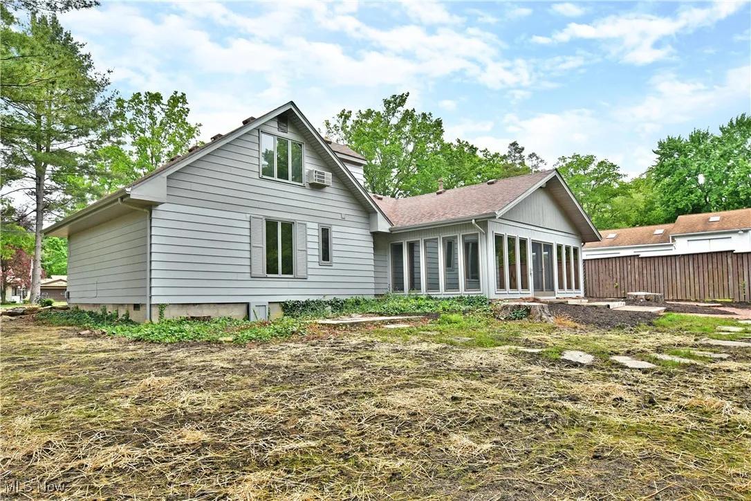 Rear view of house featuring a sunroom