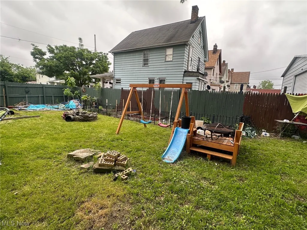 View of playground featuring a fire pit