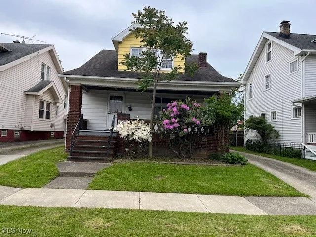Bungalow-style home with a porch and a front yard