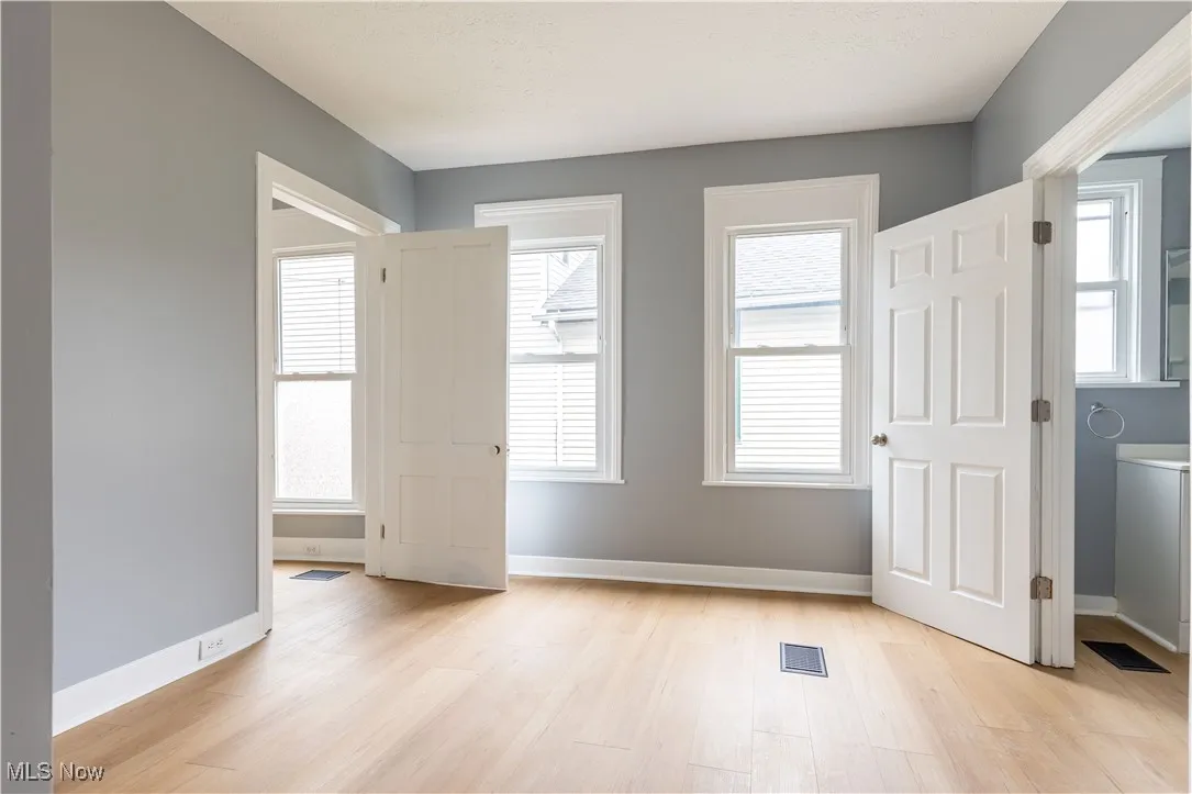Empty room featuring light wood-type flooring and baseboards