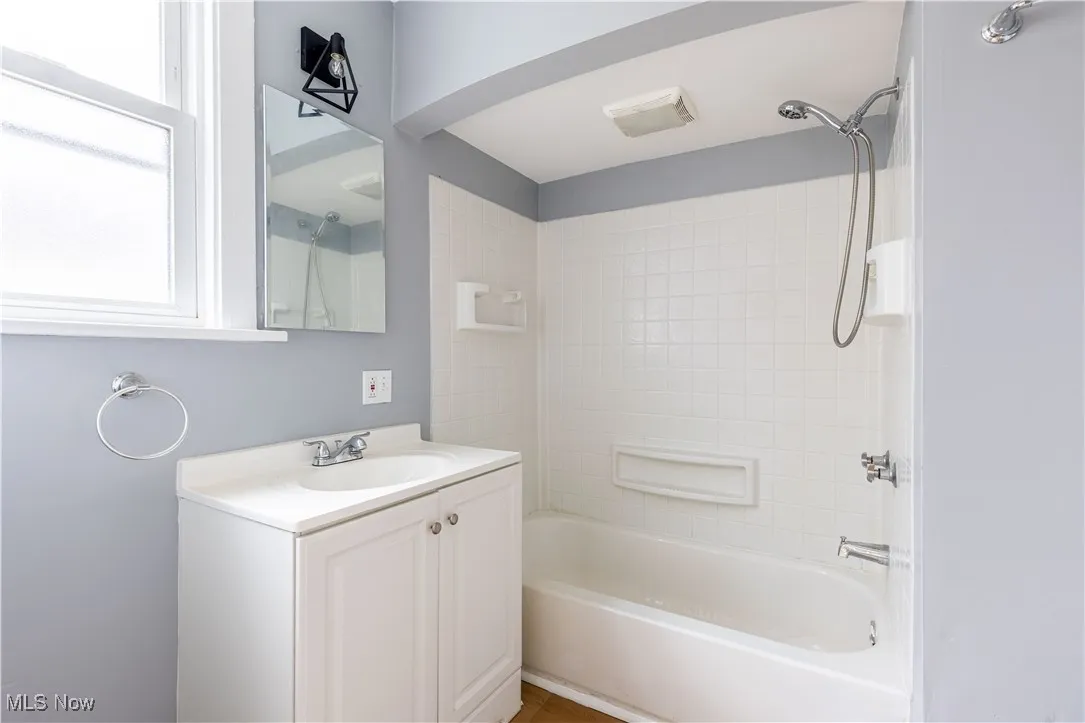 Bathroom with vanity and  shower combination