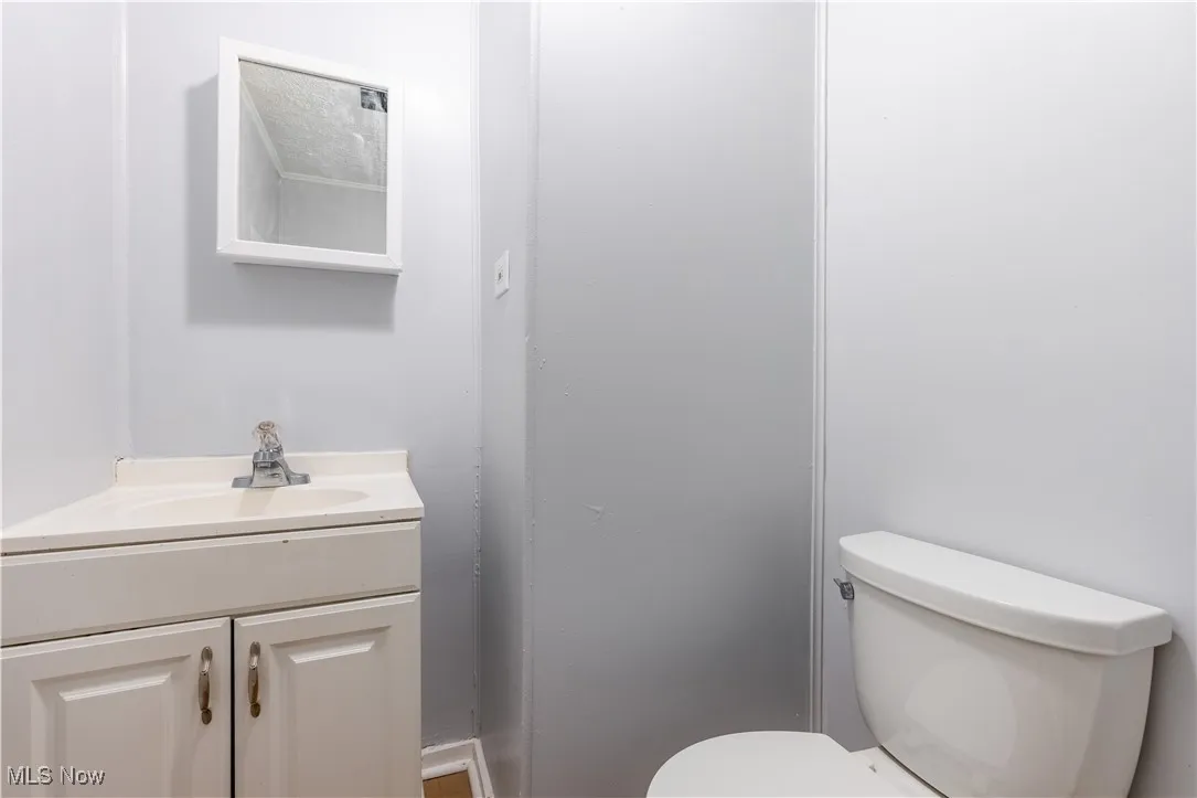Half bathroom with vanity and toilet
