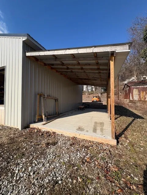 View of parking / parking lot with a carport