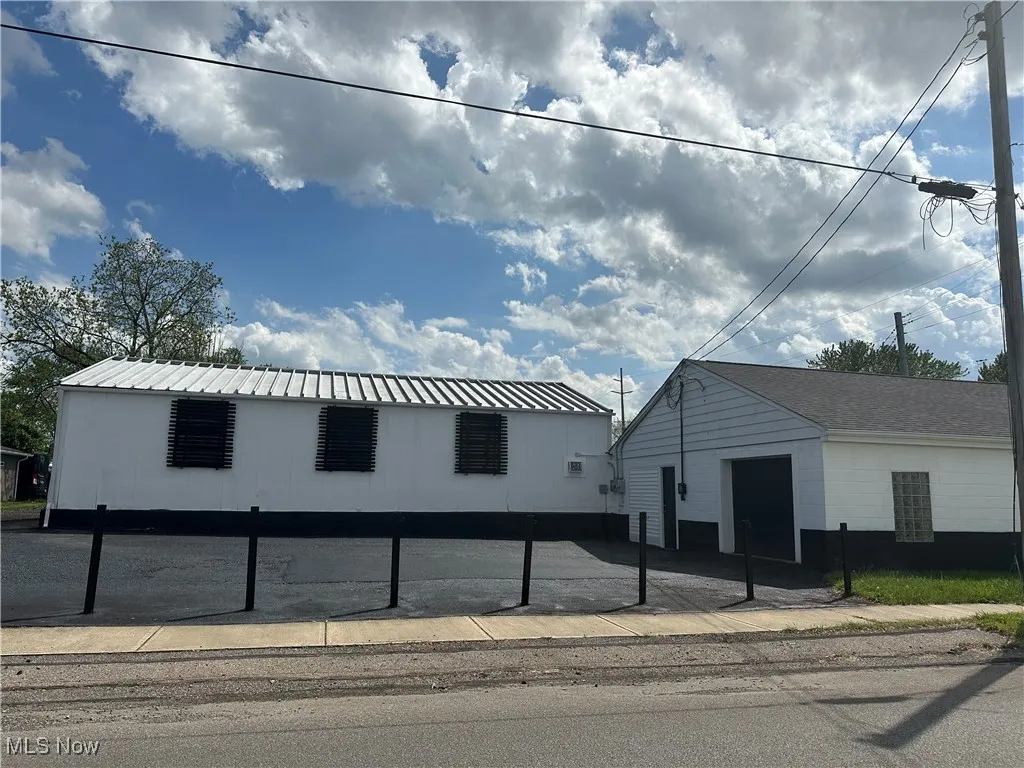 View of building exterior with a detached garage