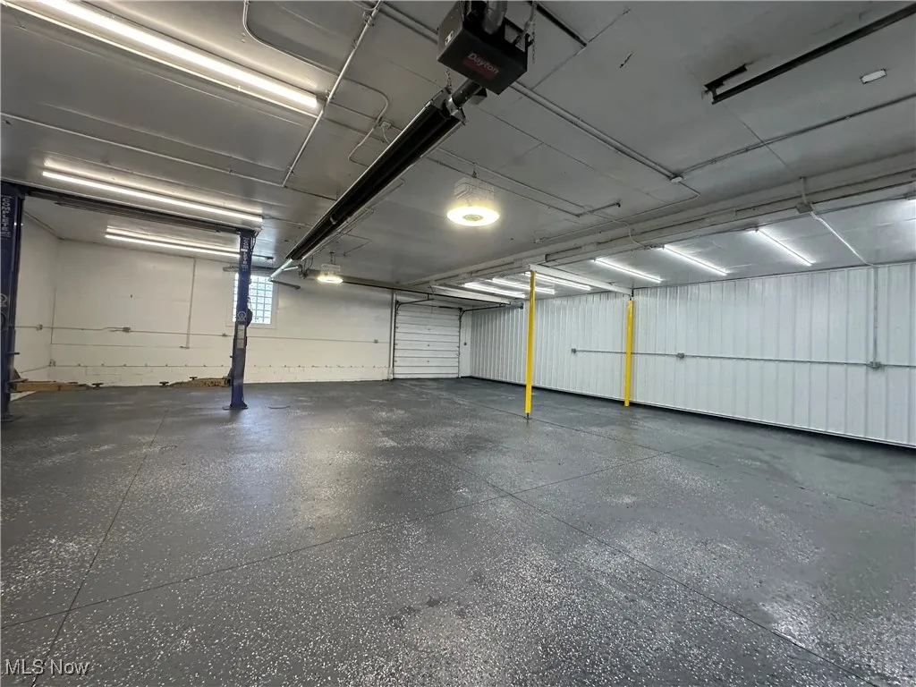 Garage featuring a garage door opener