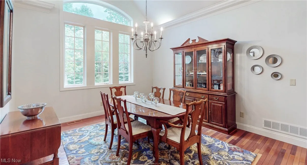 Dining area featuring plenty of natural light, light wood-style floors, baseboards, and lofted ceiling