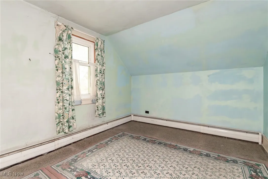 Bonus room with vaulted ceiling and baseboard heating