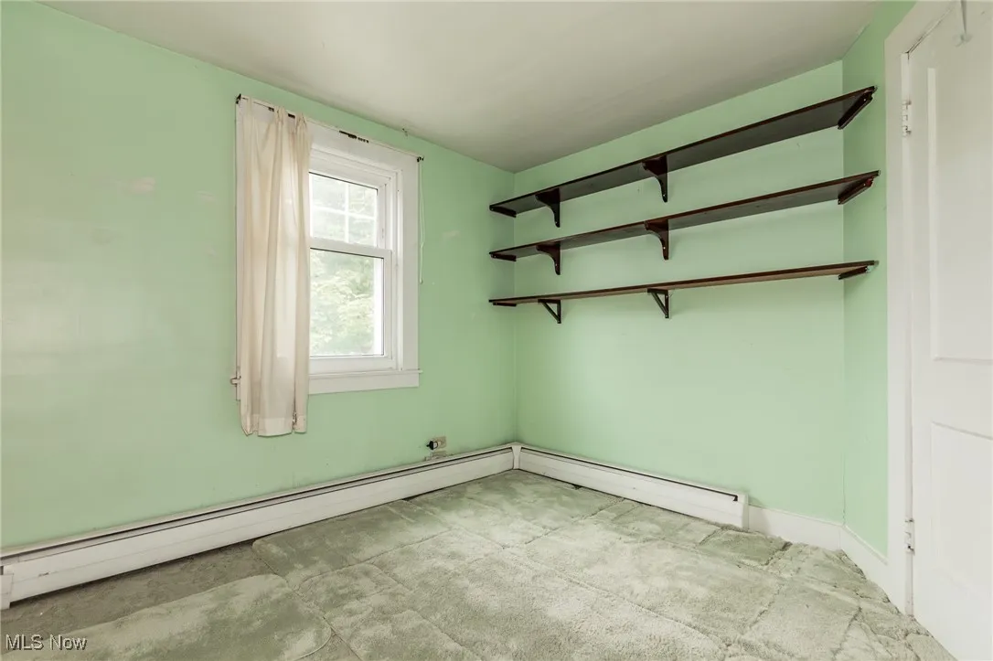 Spare room with a baseboard radiator