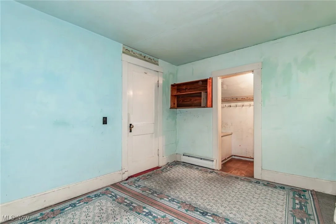 Spare room featuring a baseboard radiator