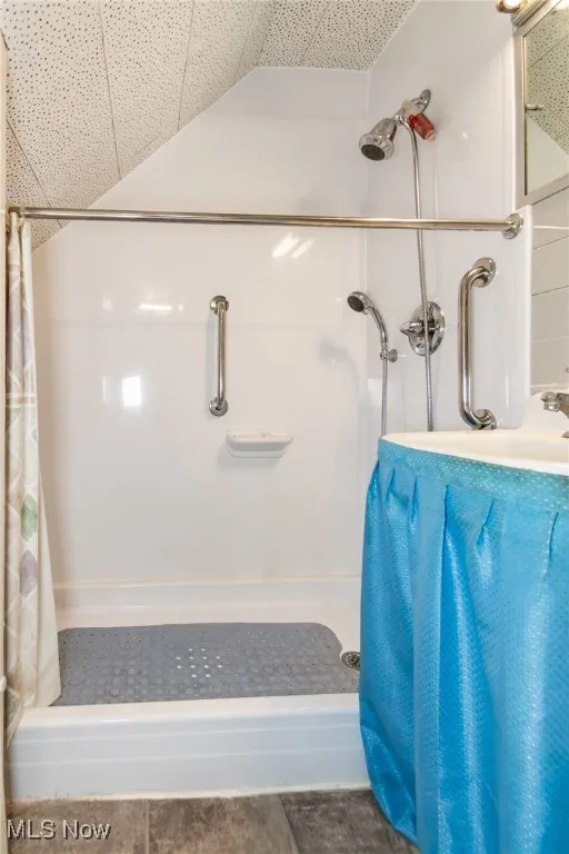 Full bath with a shower with curtain