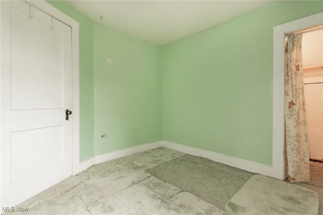 Unfurnished bedroom with baseboards and carpet floors