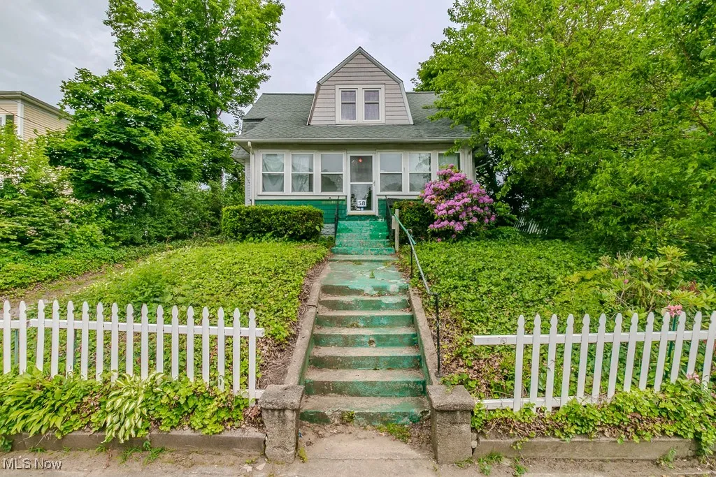 Bungalow featuring stairway and a shingled roof