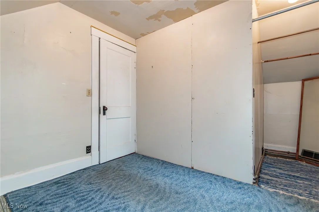 Unfurnished bedroom featuring carpet