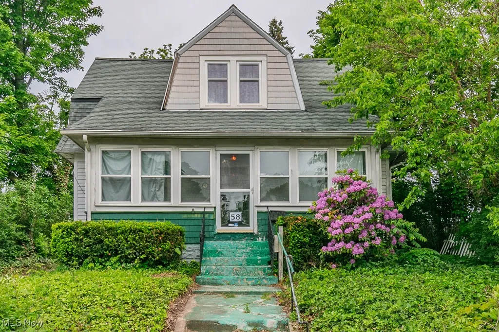 View of front of house featuring a shingled roof