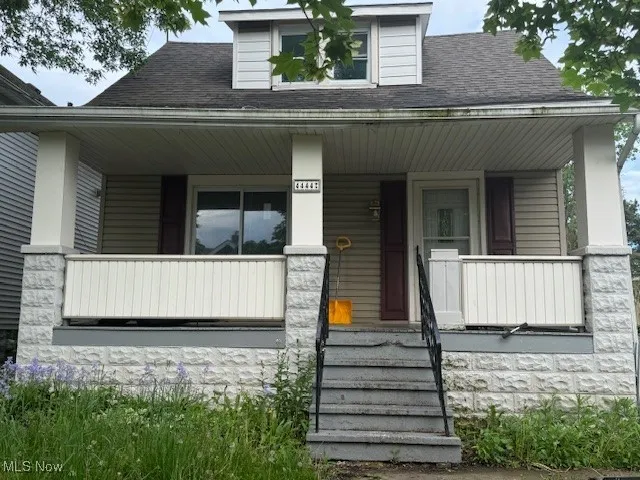 Bungalow featuring a porch and roof with shingles