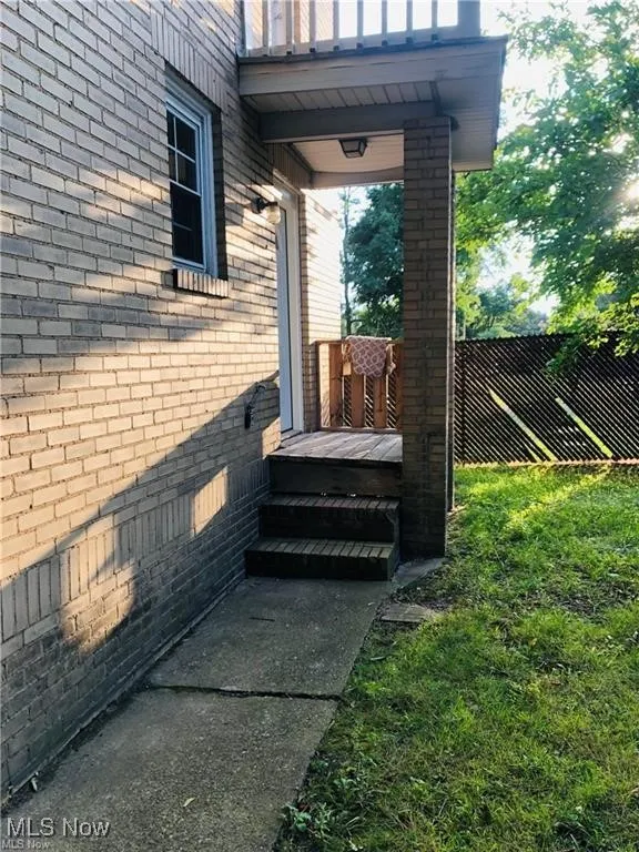 Property entrance featuring brick siding