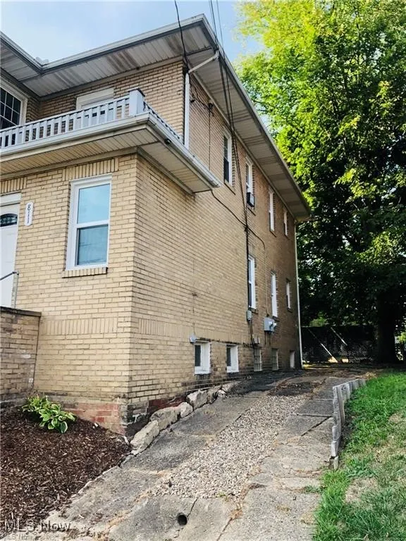 View of side of home with brick siding
