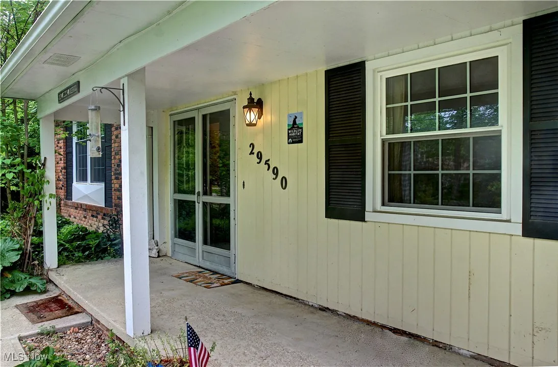 Entrance to property featuring covered porch