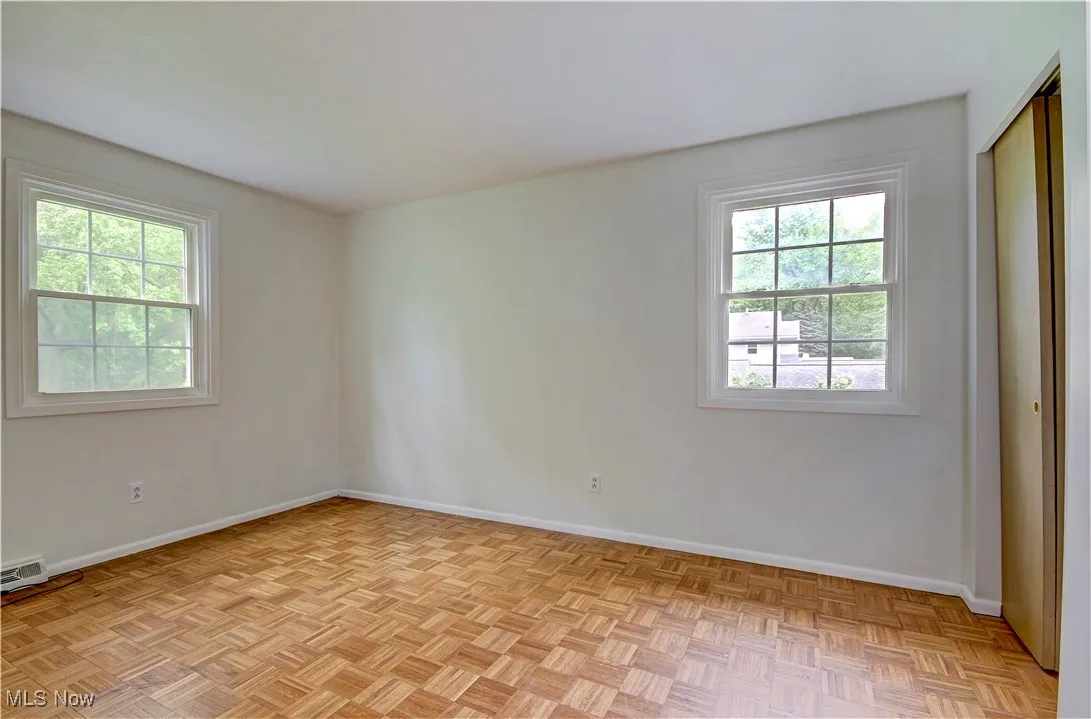 Unfurnished room with plenty of natural light and baseboards