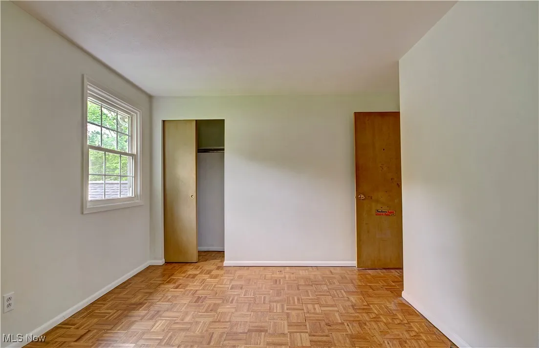 Unfurnished bedroom featuring baseboards and a closet