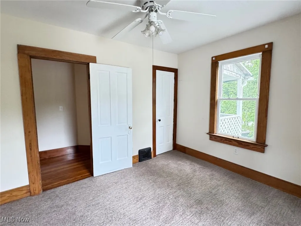 2nd floor bedroom featuring carpet, baseboards, and a ceiling fan