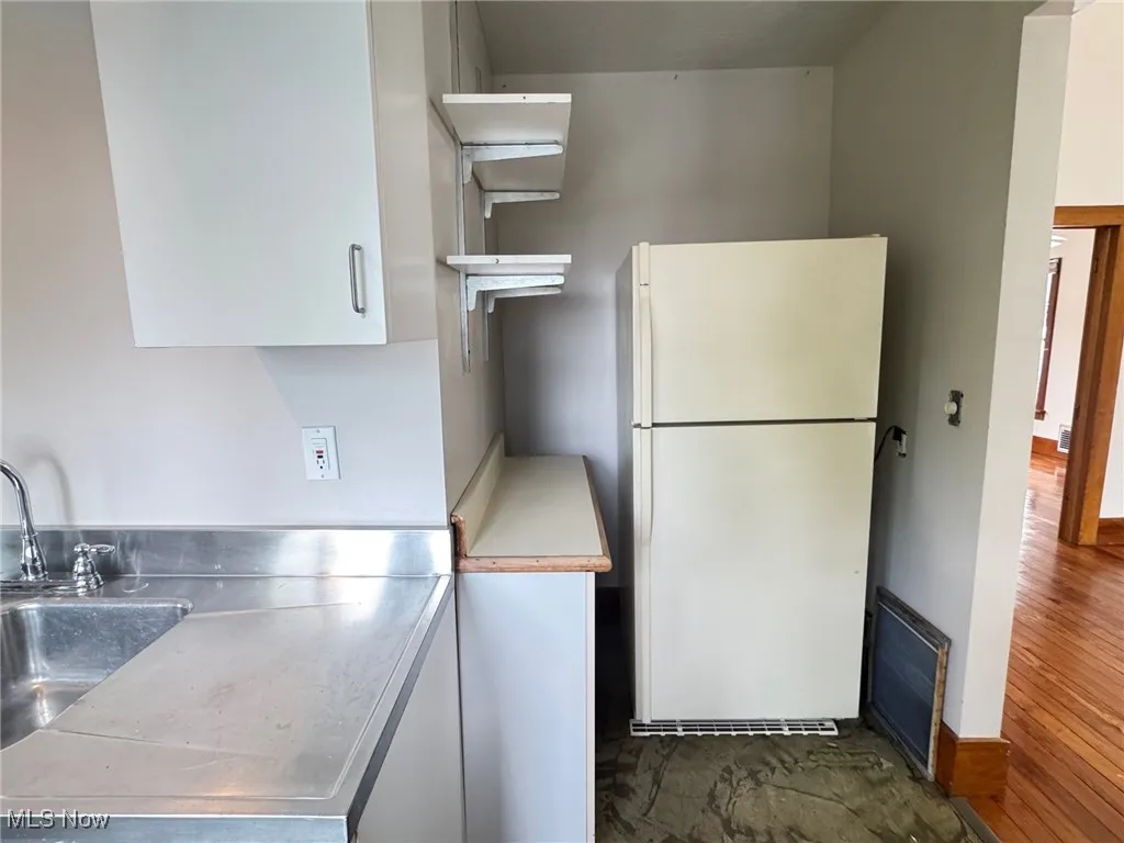 2nd floor Kitchen with stainless steel countertops, freestanding refrigerator, a sink, dark wood-type flooring, and white cabinets