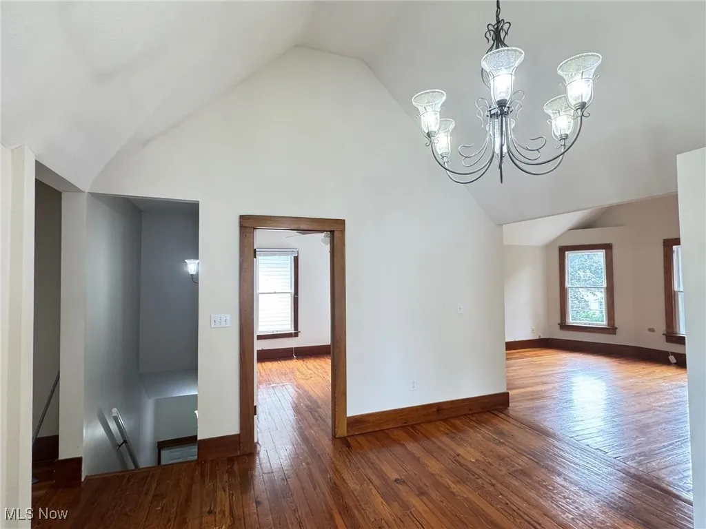 2nd floor dining roomfeaturing vaulted ceiling, plenty of natural light, wood-type flooring, and baseboards