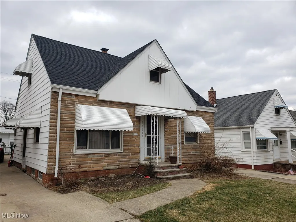Bungalow-style home featuring roof with shingles, a chimney, and board and batten siding