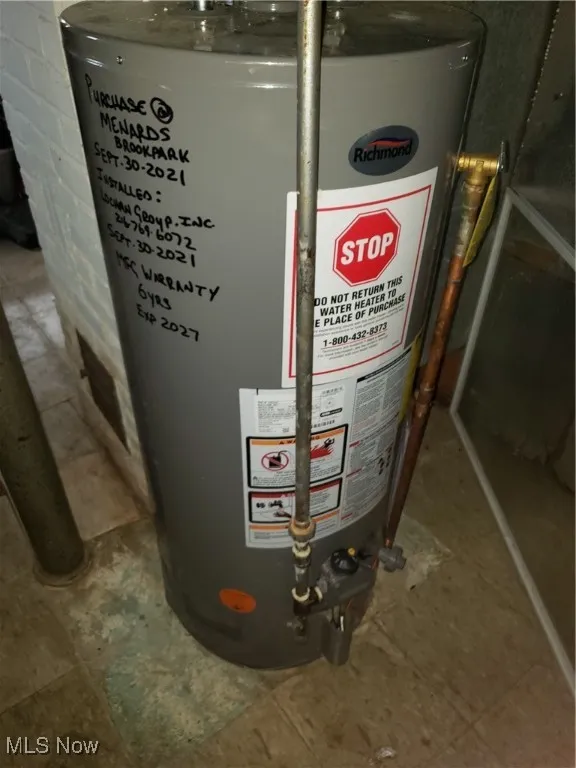 Utility room featuring gas water heater
