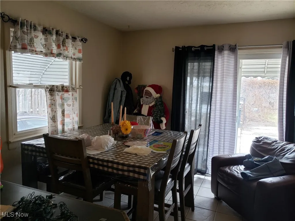 Dining area with light tile patterned flooring
