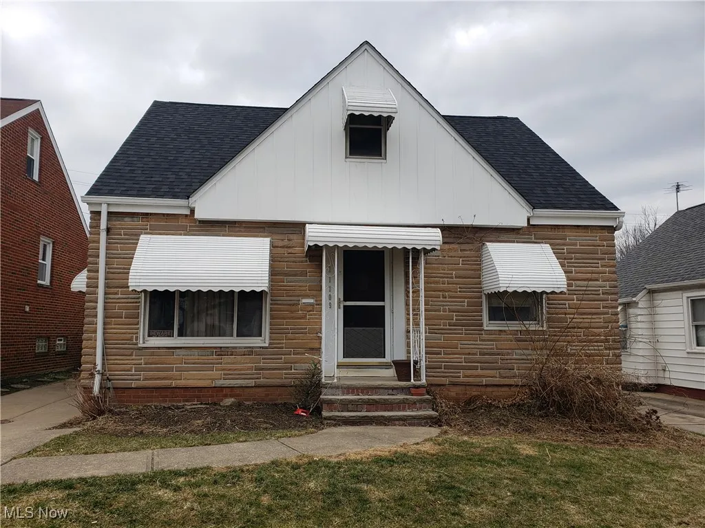 View of front of home featuring a shingled roof, board and batten siding, and entry steps