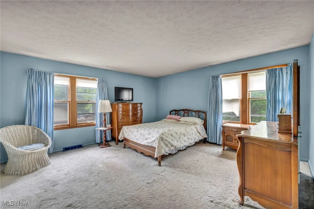 Bedroom featuring carpet floors and a textured ceiling