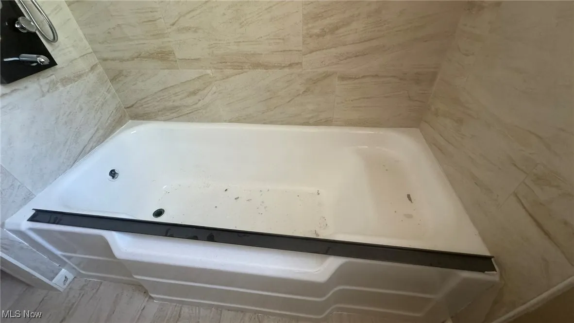 Full bathroom with a tub