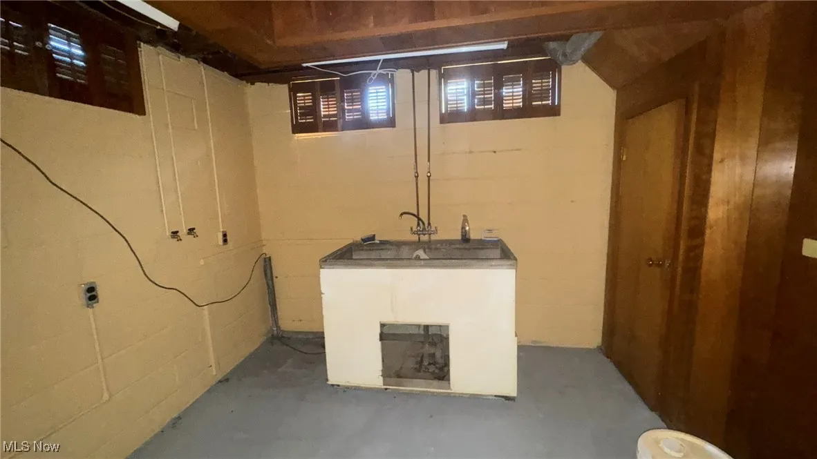 Basement with concrete block wall and wet bar
