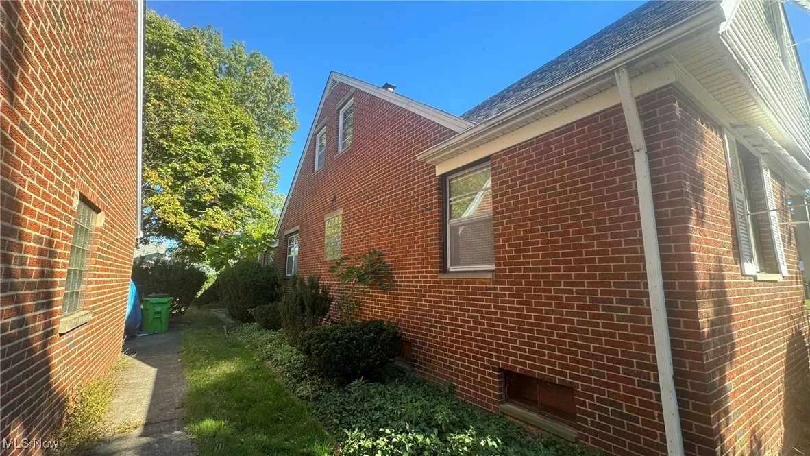 View of side of property with brick siding